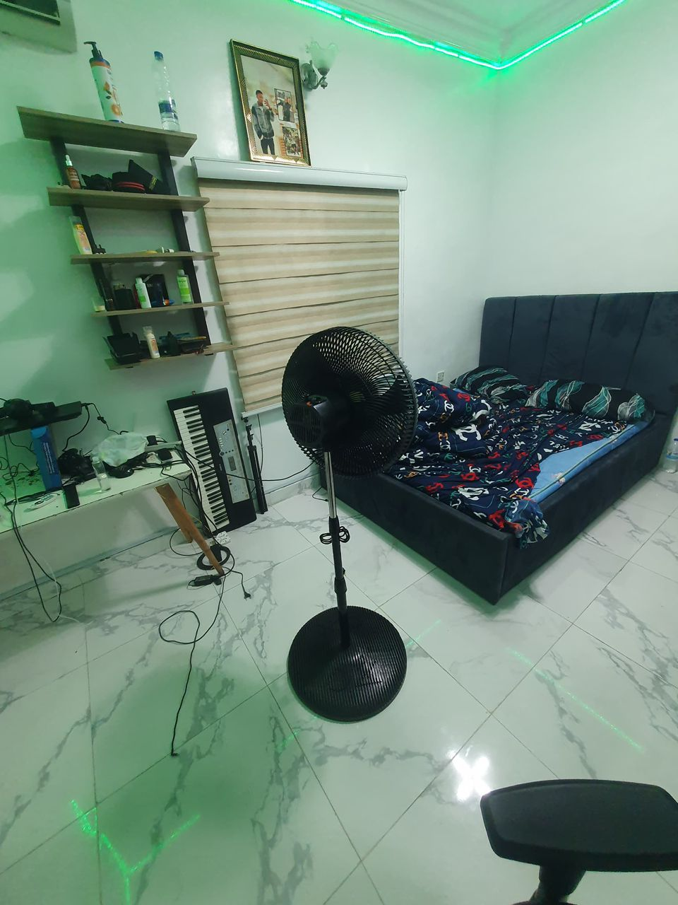 Mini flat room with LED ceiling lighting, marble floor tiles and upholstered bed at Rilwan AJALA Homes