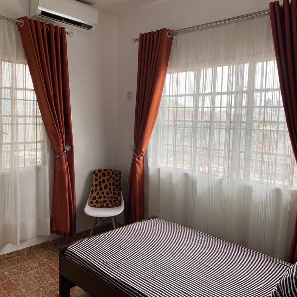 Private single room at Rilwan AJALA Homes Yaba Lagos with air conditioning and terracotta curtains